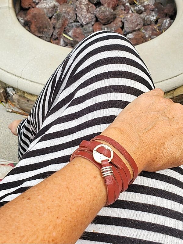 wearing a long leather wrap bracelet by the fire